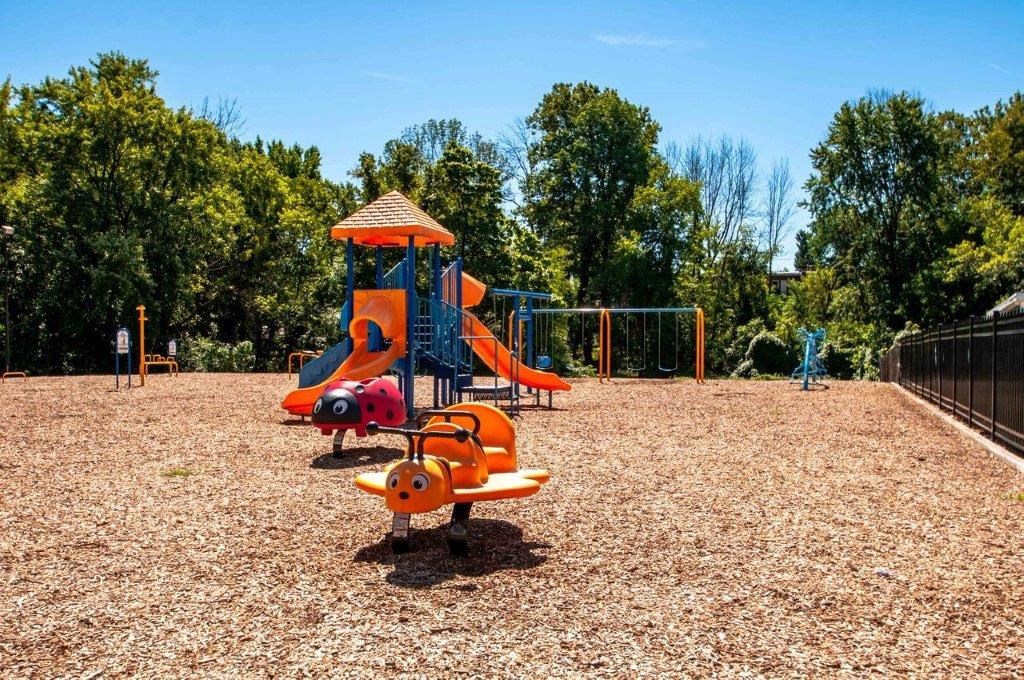 a playground with a swing set and other playground equipment