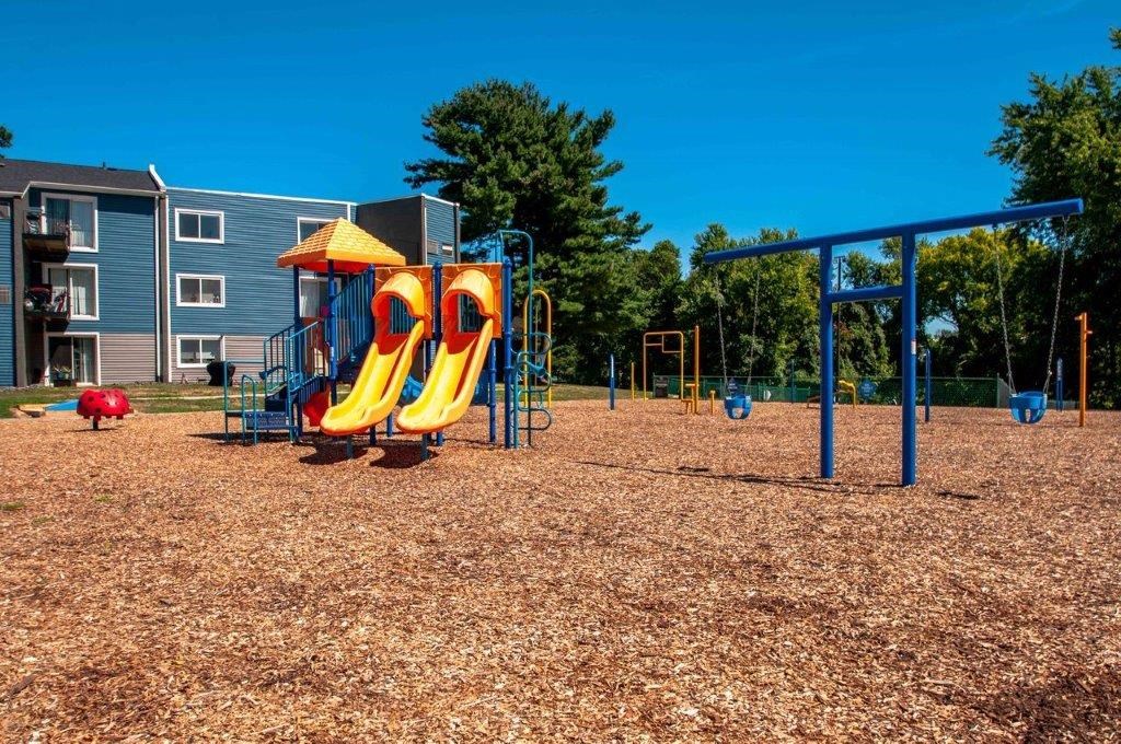 a playground with a swing set and slides