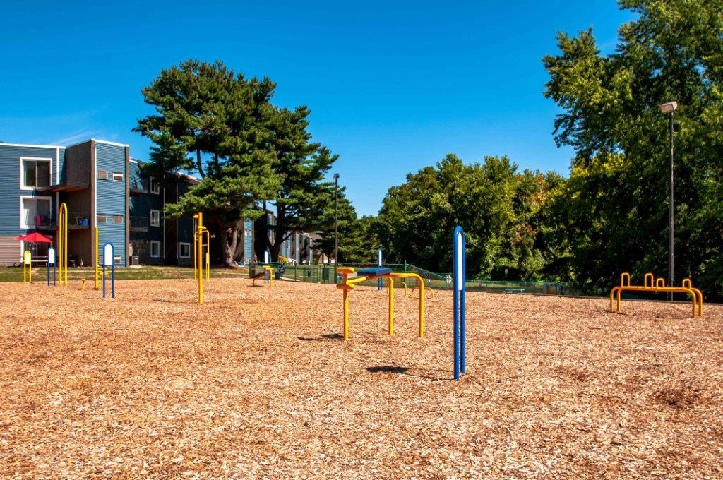 a playground in a park near a building