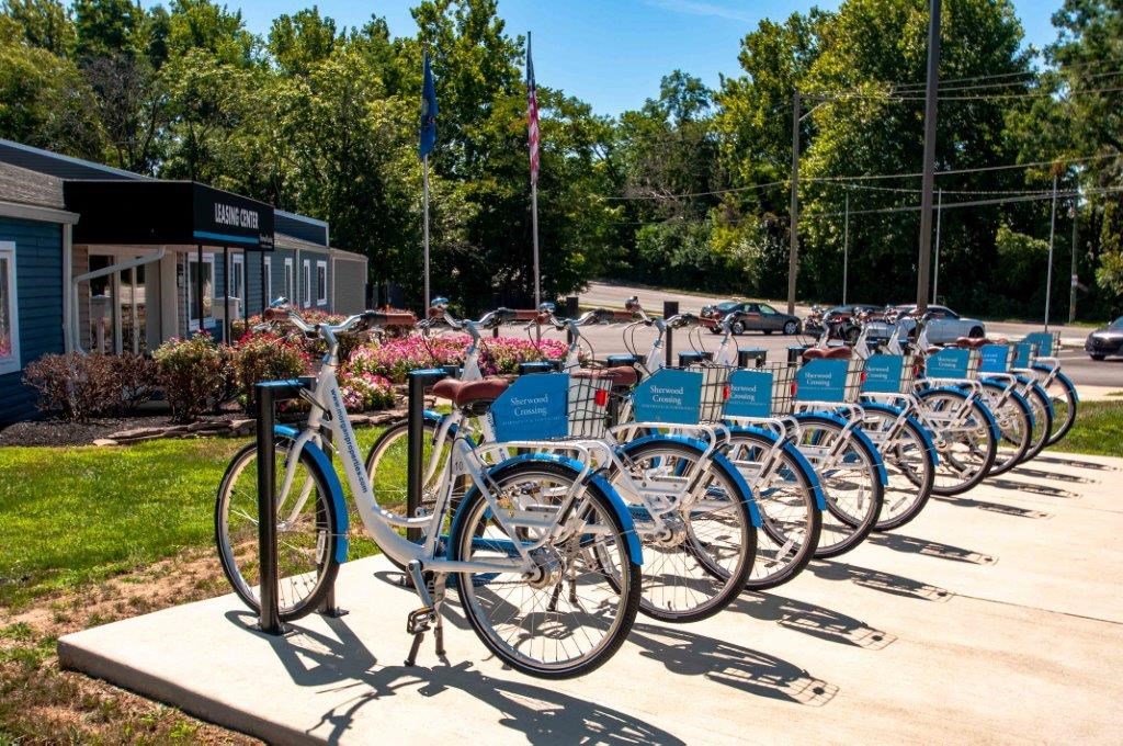a row of bikes parked next to each other on a sidewalk