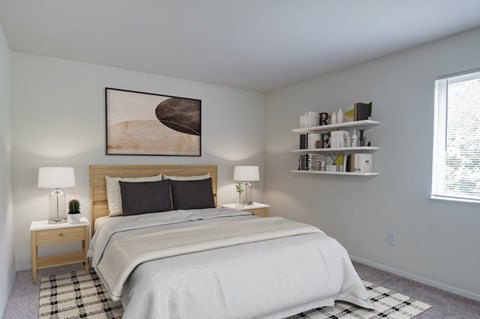 A bedroom with a large bed and a painting on the wall.