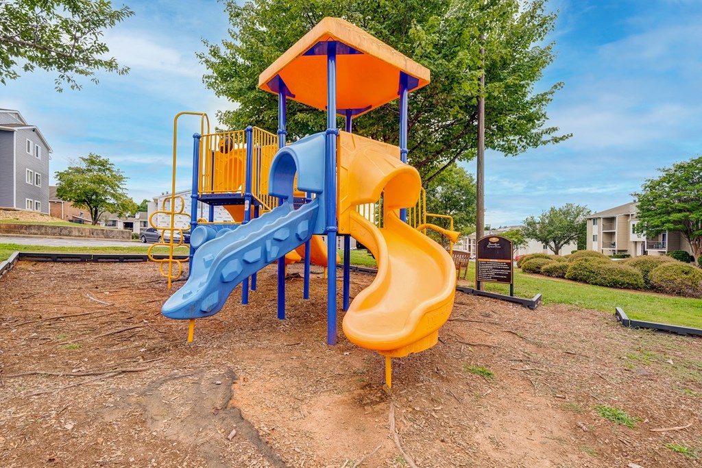 a playground with a blue and yellow swing set