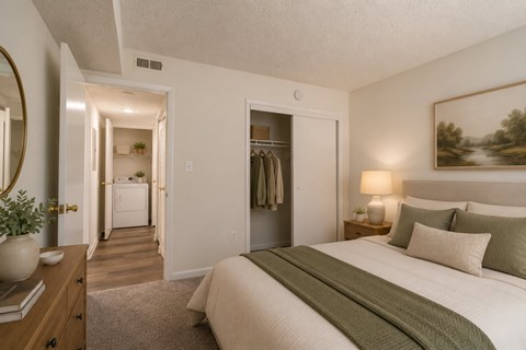 A bedroom with a large bed and a painting on the wall.