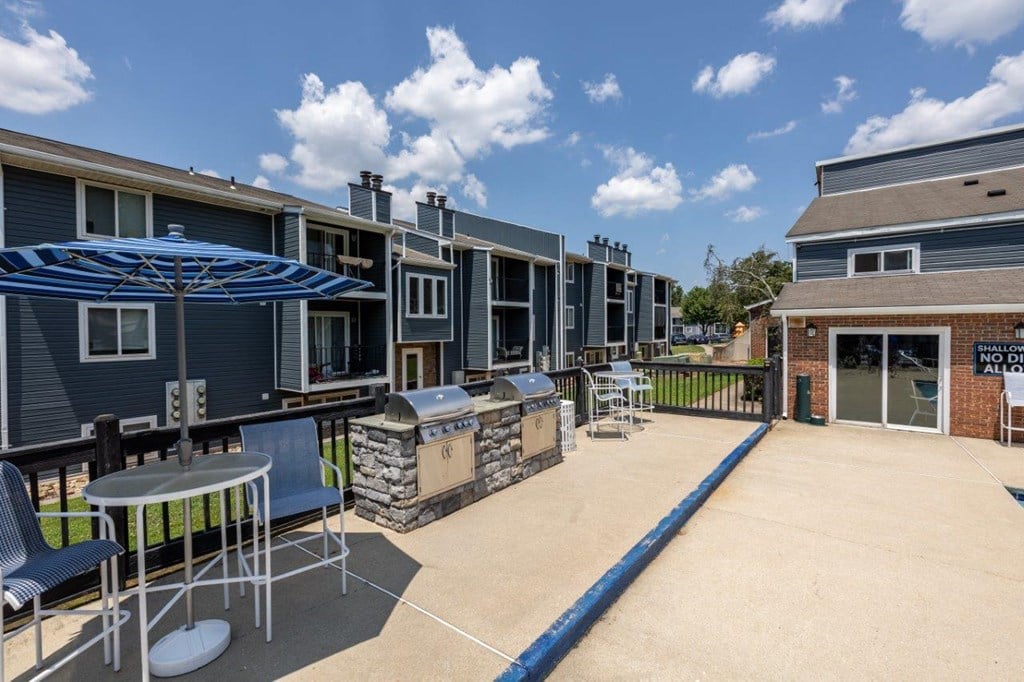 our apartments have a large patio with tables and chairs