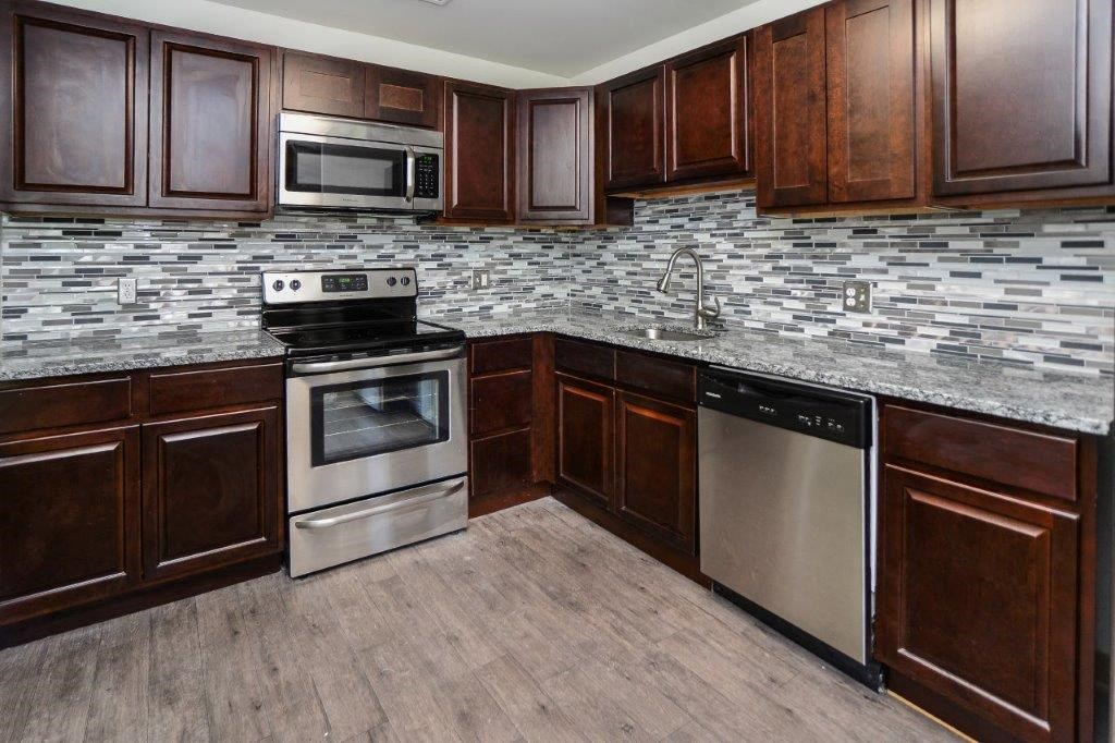 a kitchen with stainless steel appliances and wooden cabinets