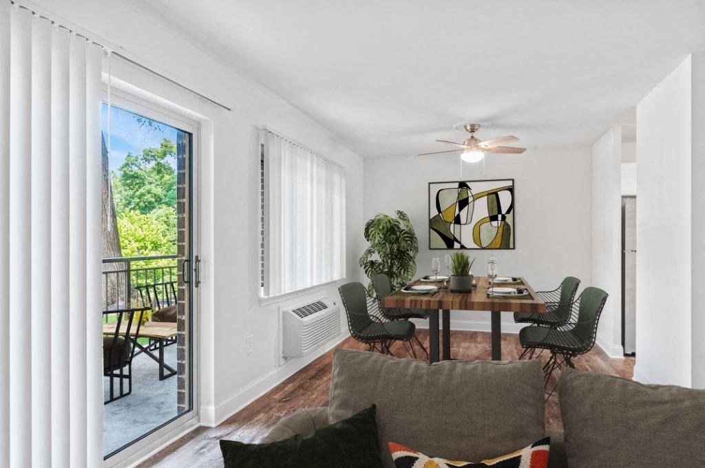 a living room with a couch and a table and a balcony