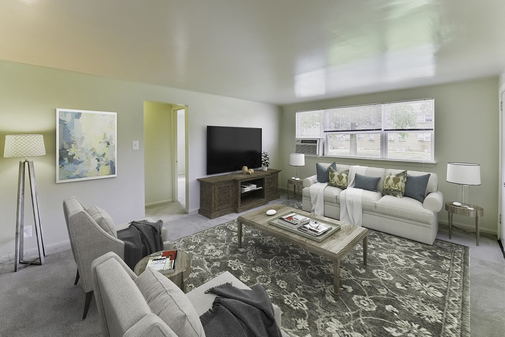 a living room with a white couch and a television