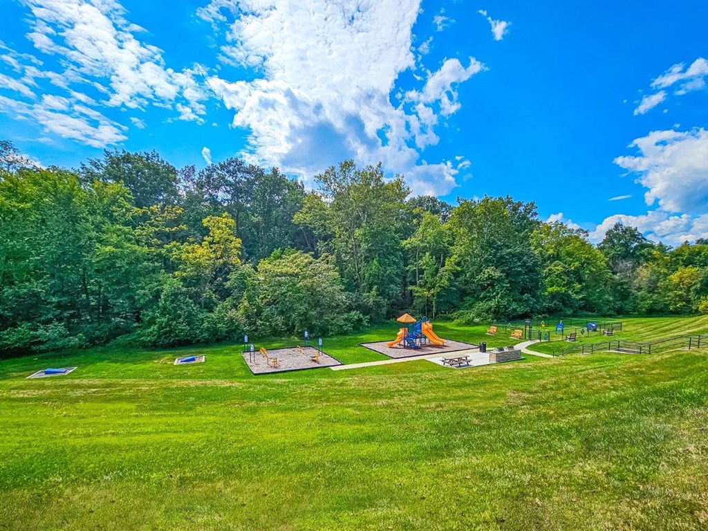 a park with a playground and a fire pit