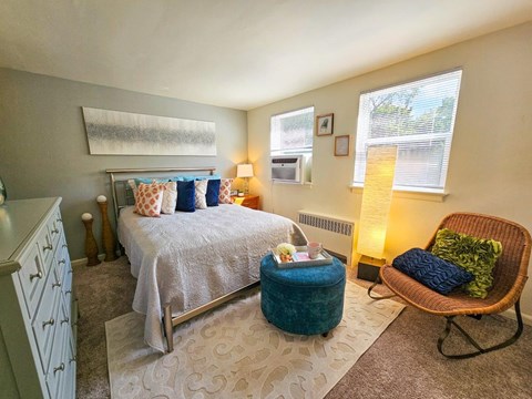 a bedroom with a bed and a chair