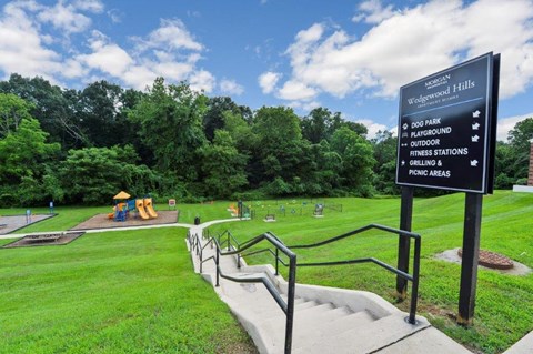 a park with stairs and a sign