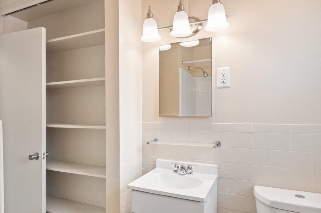 a white bathroom with a sink and a mirror