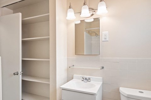 a white bathroom with a sink and a mirror