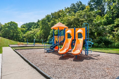 a playground with a slide and a swing set