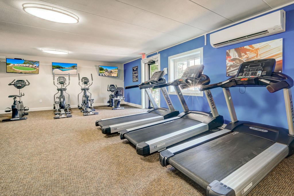 a gym with treadmills and other exercise equipment