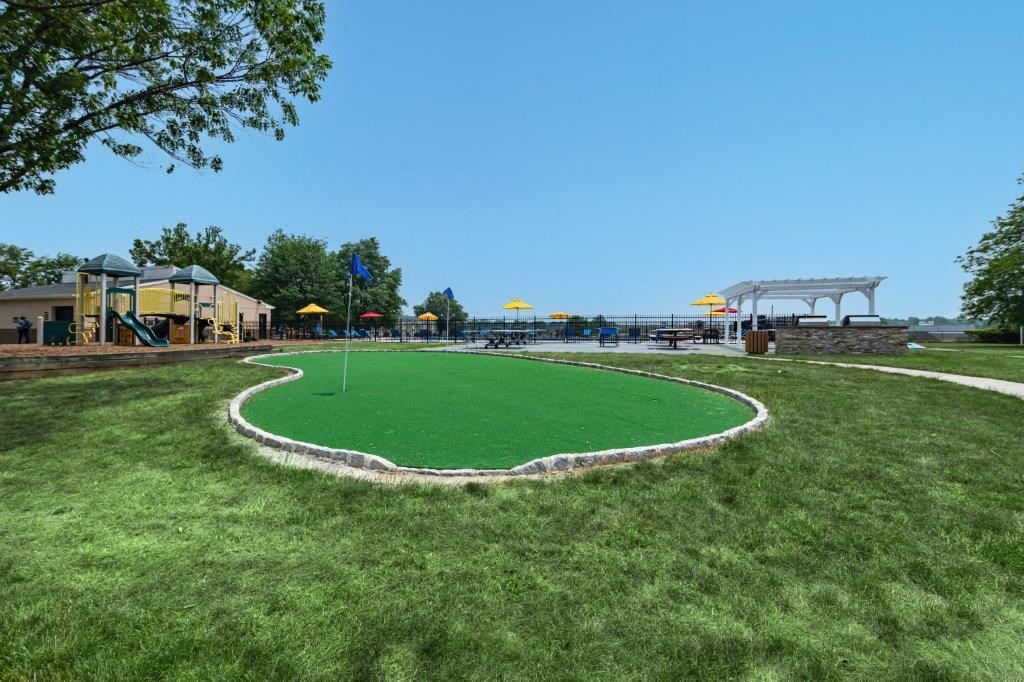 a park with an artificial turf field and a playground