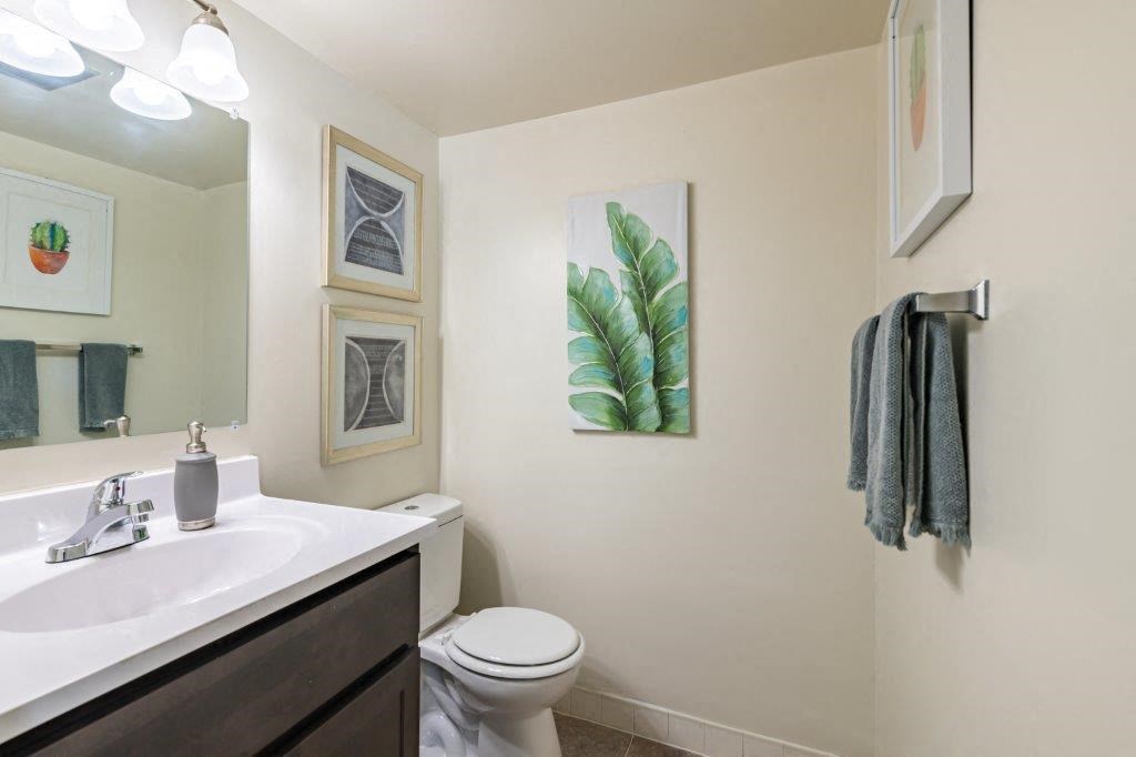 a bathroom with a sink and a toilet and a mirror
