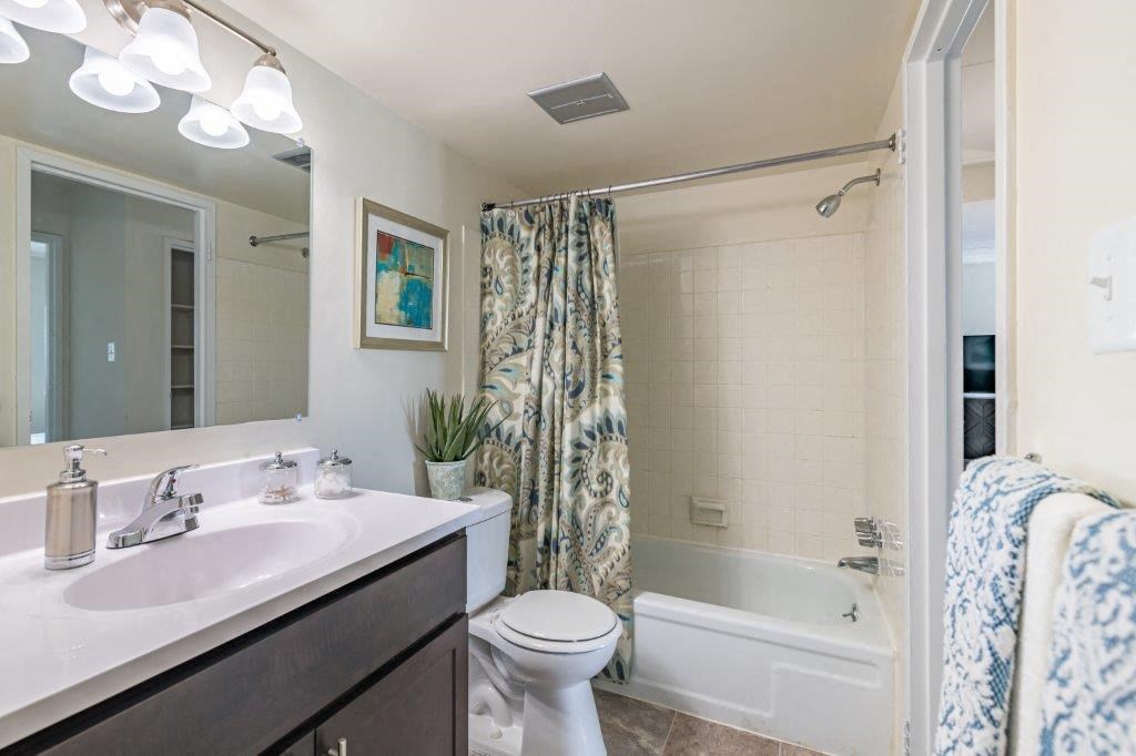 a bathroom with a sink and a toilet and a shower