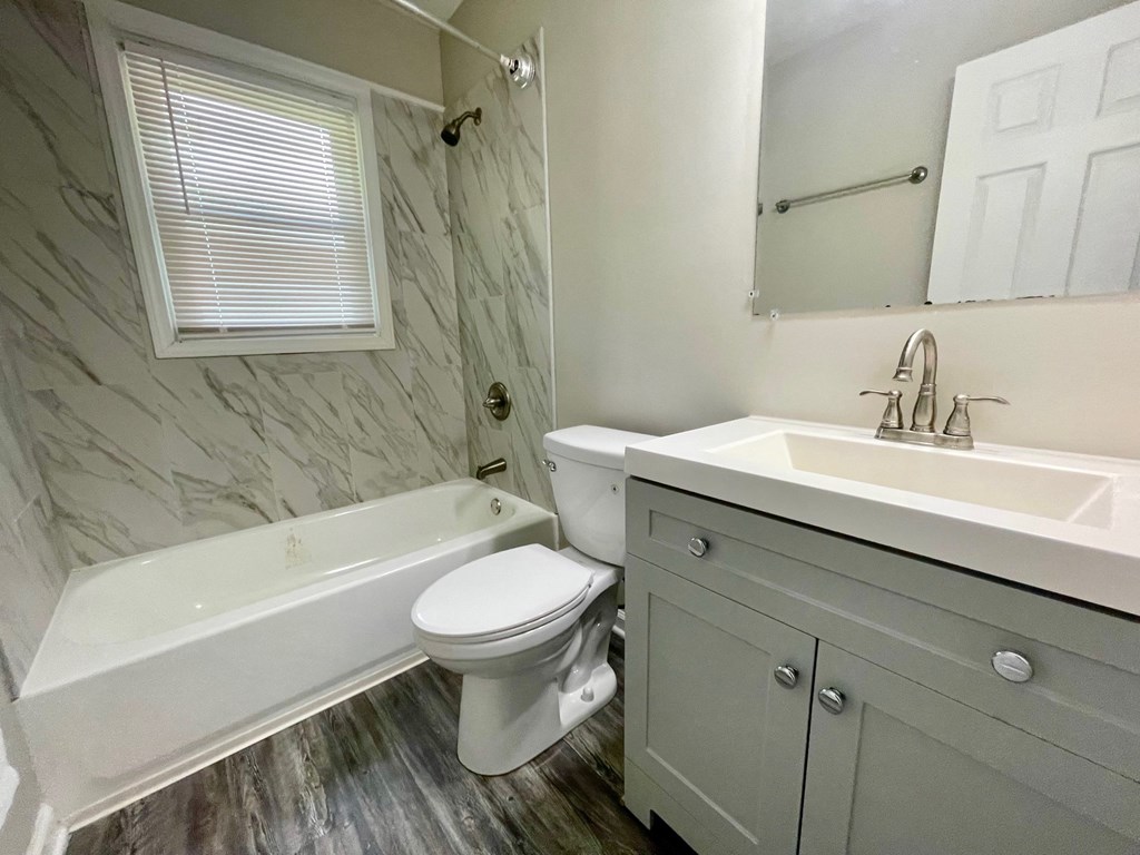 a bathroom with a sink toilet and a bath tub