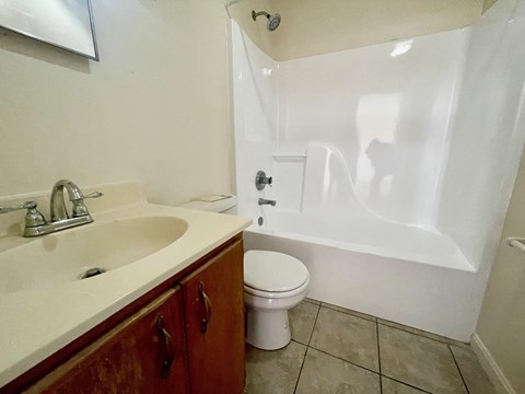 a bathroom with a sink toilet and a tub