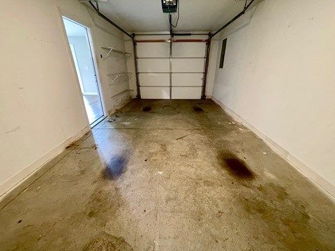 the inside of a garage with water stains on the floor