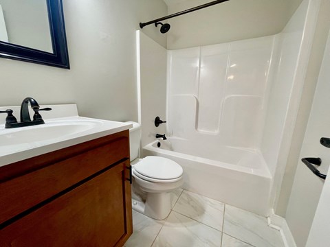 a bathroom with a toilet and a sink and a tub