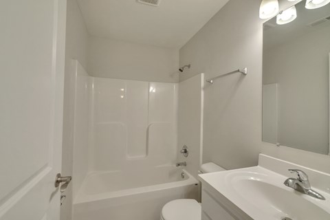 a bathroom with a sink and a shower and a toilet