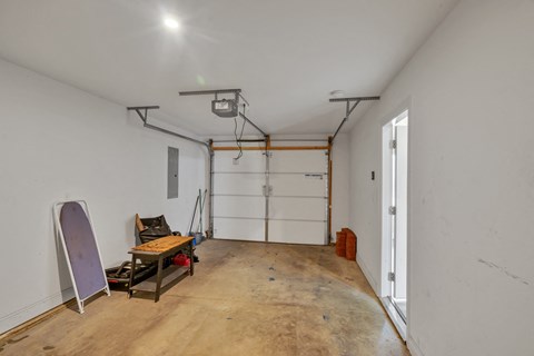 a room with a white wall and a garage door