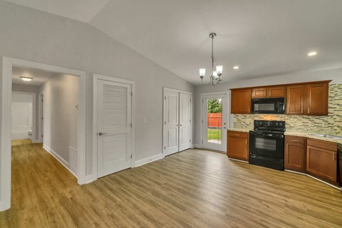 the kitchen and living room of a house with wood flooring and