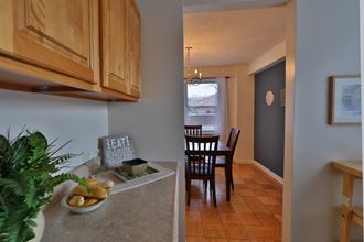 a kitchen and dining room with a table and chairs
