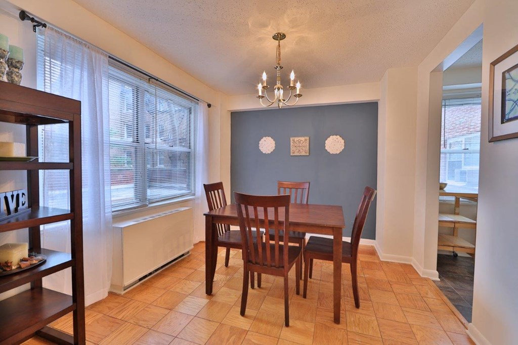 a dining room with a wooden table and chairs