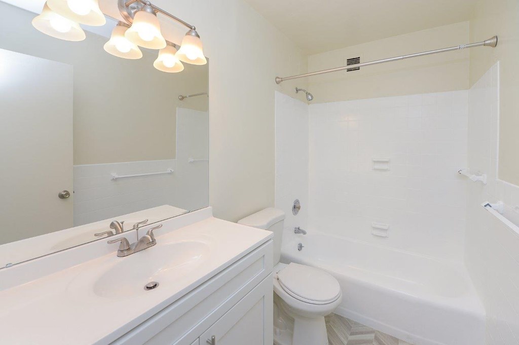 a white bathroom with a sink and a toilet