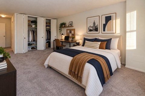 A bedroom with a large bed and a wardrobe.