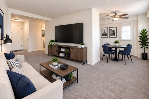 A living room with a white couch and a television.
