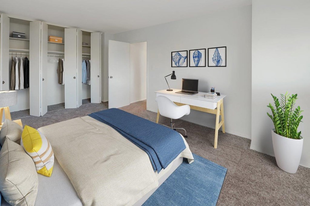 a bedroom with a bed and a desk