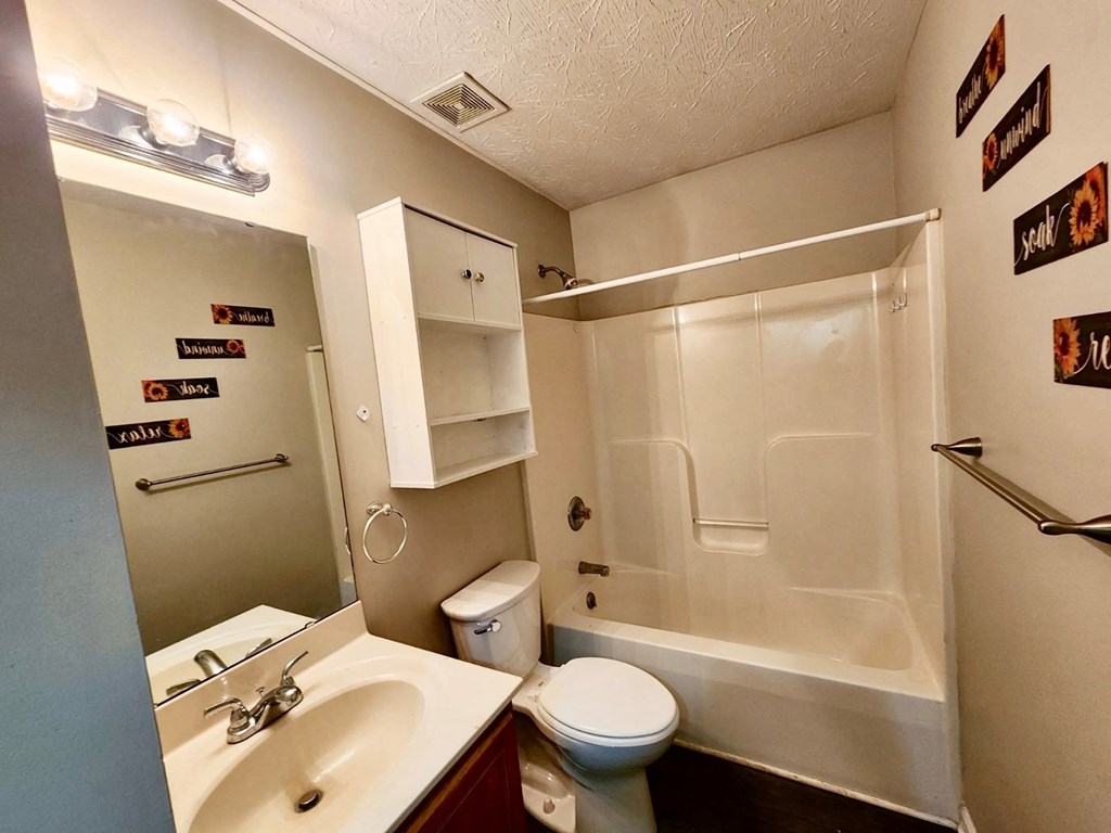a bathroom with a sink toilet and a shower