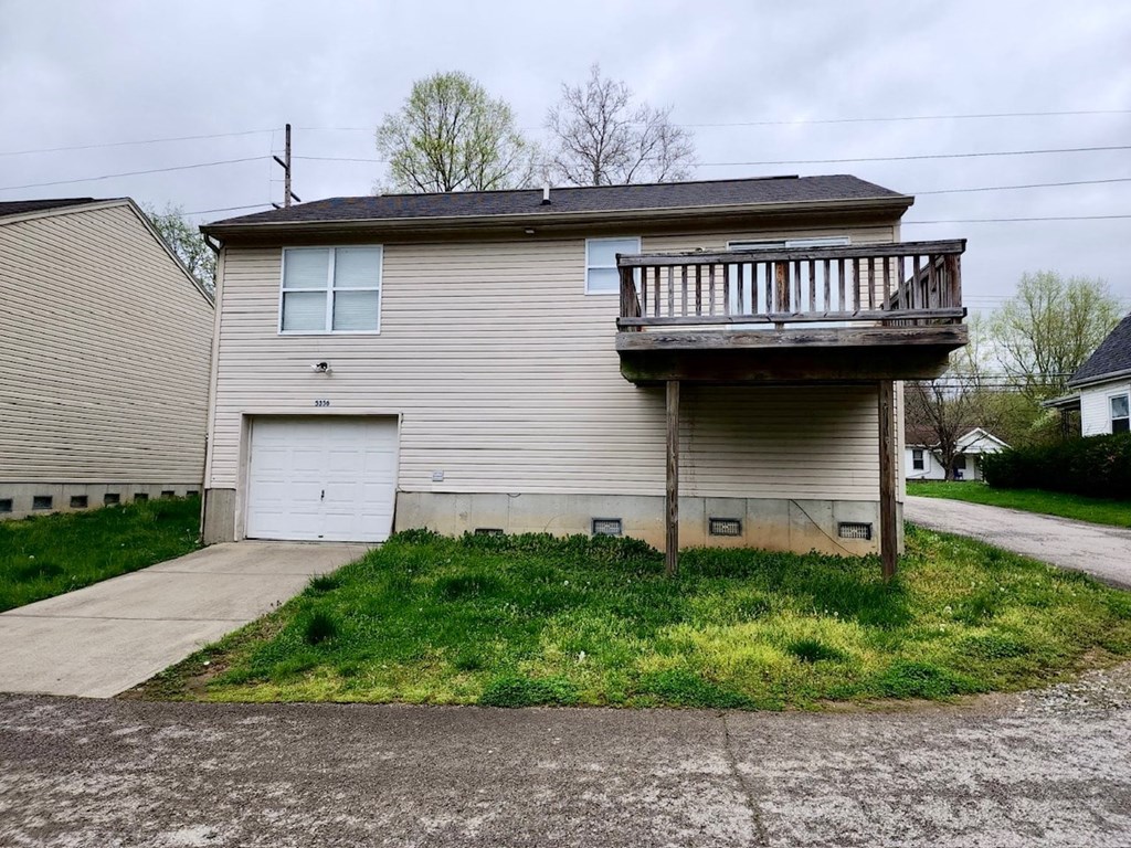 a white house with a deck on top of it