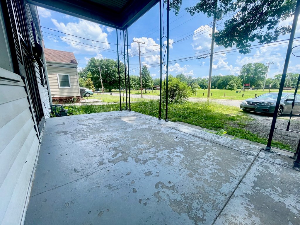 the front porch of a house with glass walls and a driveway