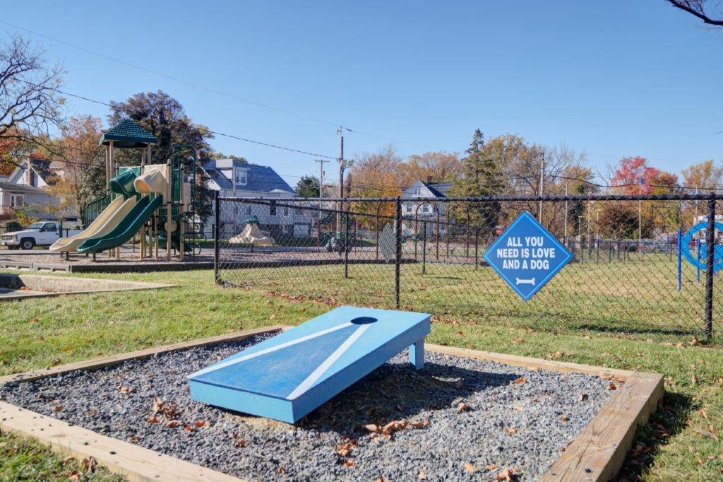 a playground with a blue bench and a slide
