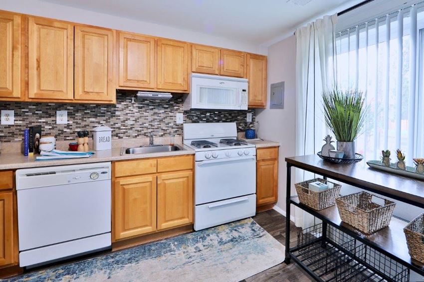 a kitchen with white appliances and wooden cabinets