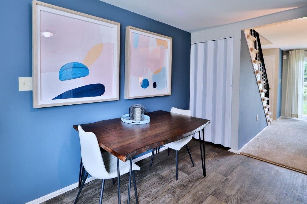 a dining room with blue walls and a table and chairs