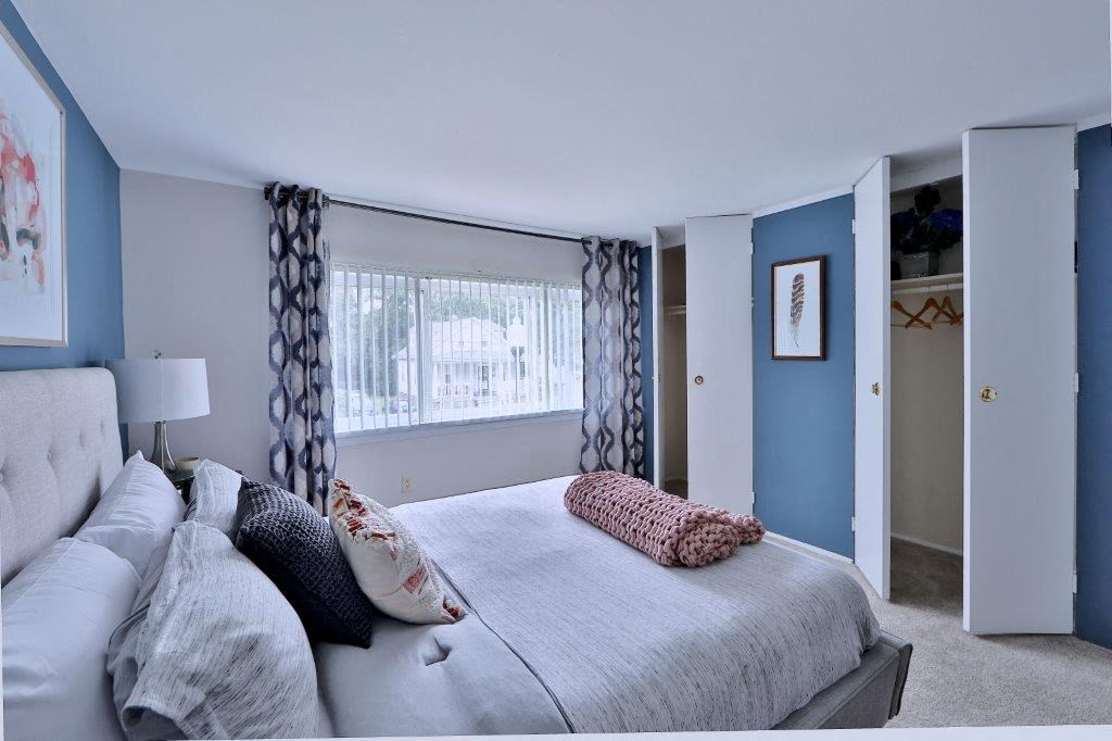 a bedroom with a large bed and a window