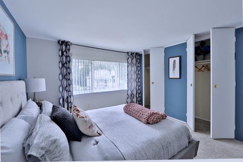 a bedroom with a large bed and a window