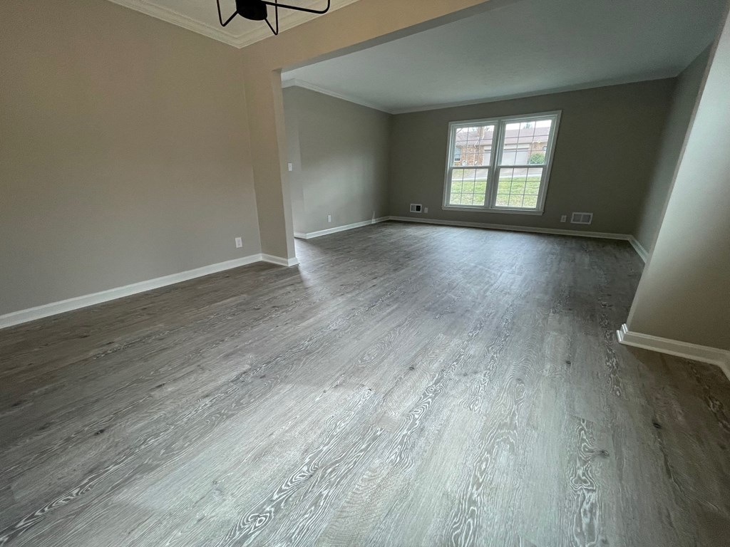 A room with a grey floor and a window.