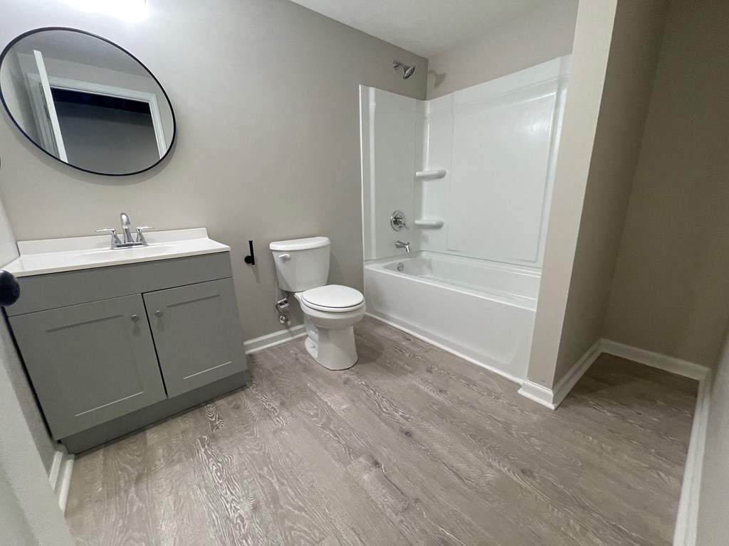 A bathroom with a toilet, sink, and bathtub.