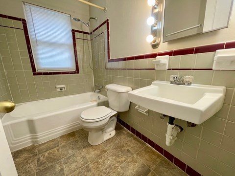 A bathroom with a white toilet and sink.