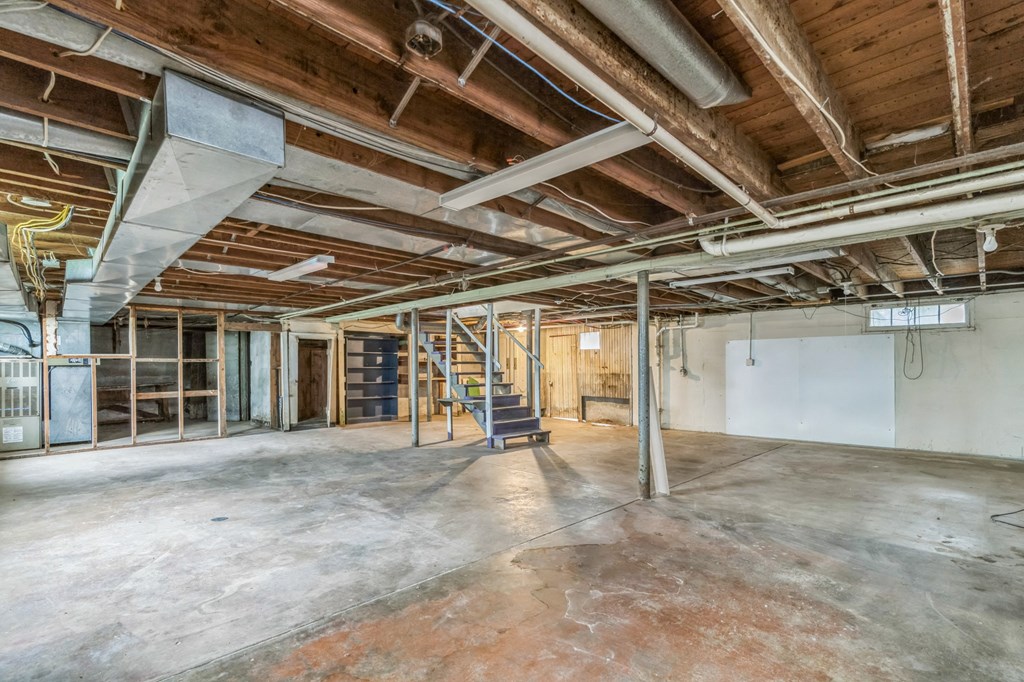 A large empty room with wooden ceiling and walls.