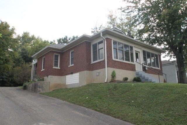 A red brick house with a white garage door.