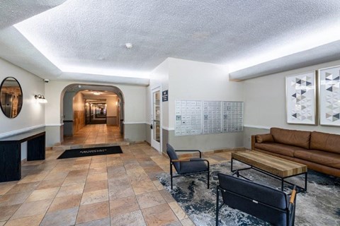 a lobby with couches and chairs and a table