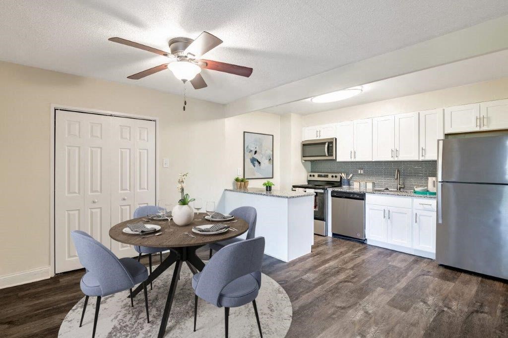 a kitchen and dining room with a ceiling fan