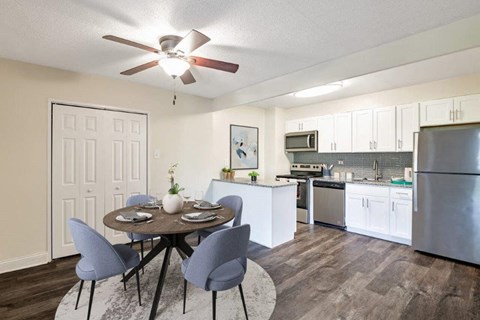 a kitchen and dining room with a ceiling fan